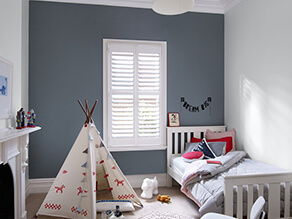 Neutral_grey_kids_room_white_fireplace_indian_tipi_nautical_pillows_blanket_white_bedframe_rug